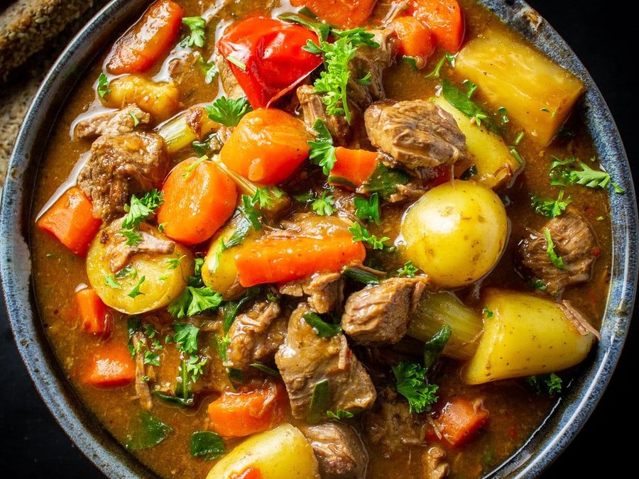 Rich beef stew in a bowl with vegetables
